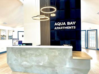 a reception area with a desk and a large sign on the side of a building